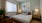 bedroom with a large window and nightstand with a lamp
